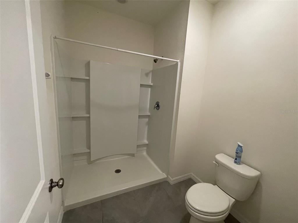 13808 Northwest 9th Road Newberry, FL 32669 - Photo 6 of 24 a bathroom with a toilet and shower