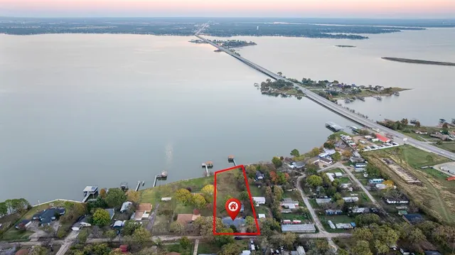 a view of a dining hall with stainless steel appliances granite countertop a stove and a table chair