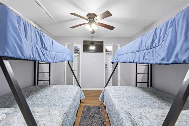 a kitchen with kitchen island a counter top space a sink stainless steel appliances and cabinets