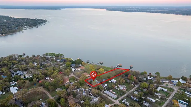a view of a roof deck with table and chairs with wooden floor and fence