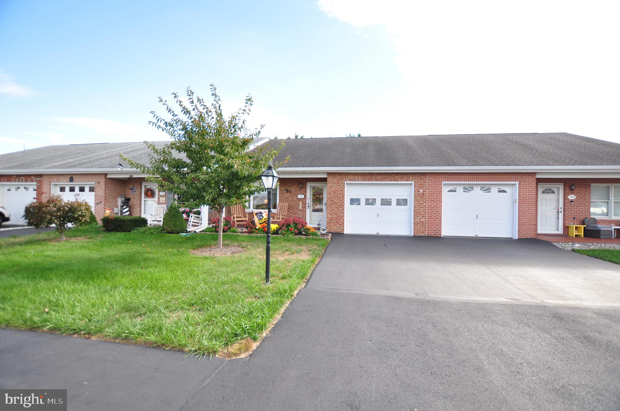 a view of a house with a yard and a garage