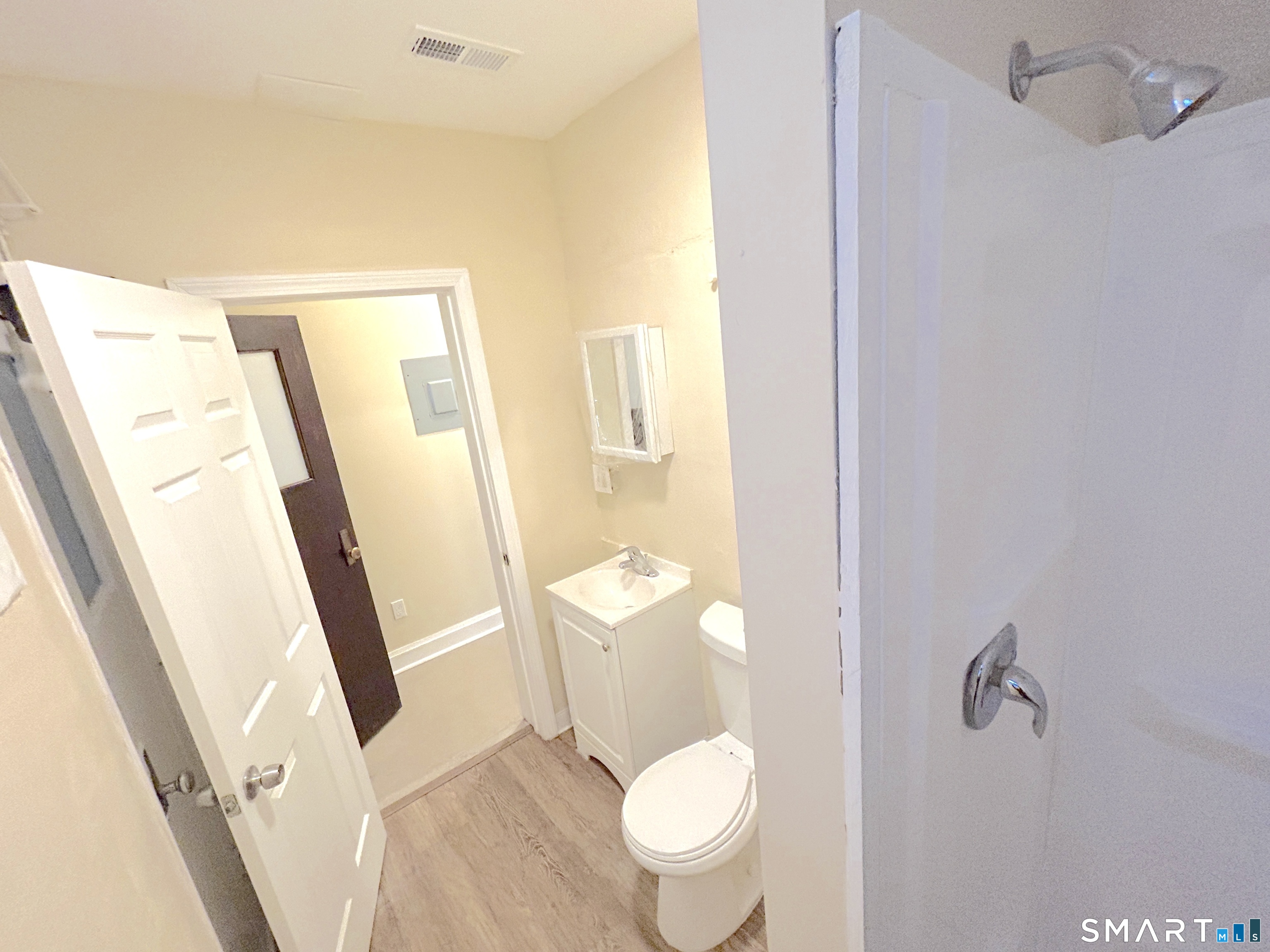 77 Bank Street, Unit 2B Waterbury, CT 06702 - Photo 5 of 11 a white toilet sitting next to a bathroom sink