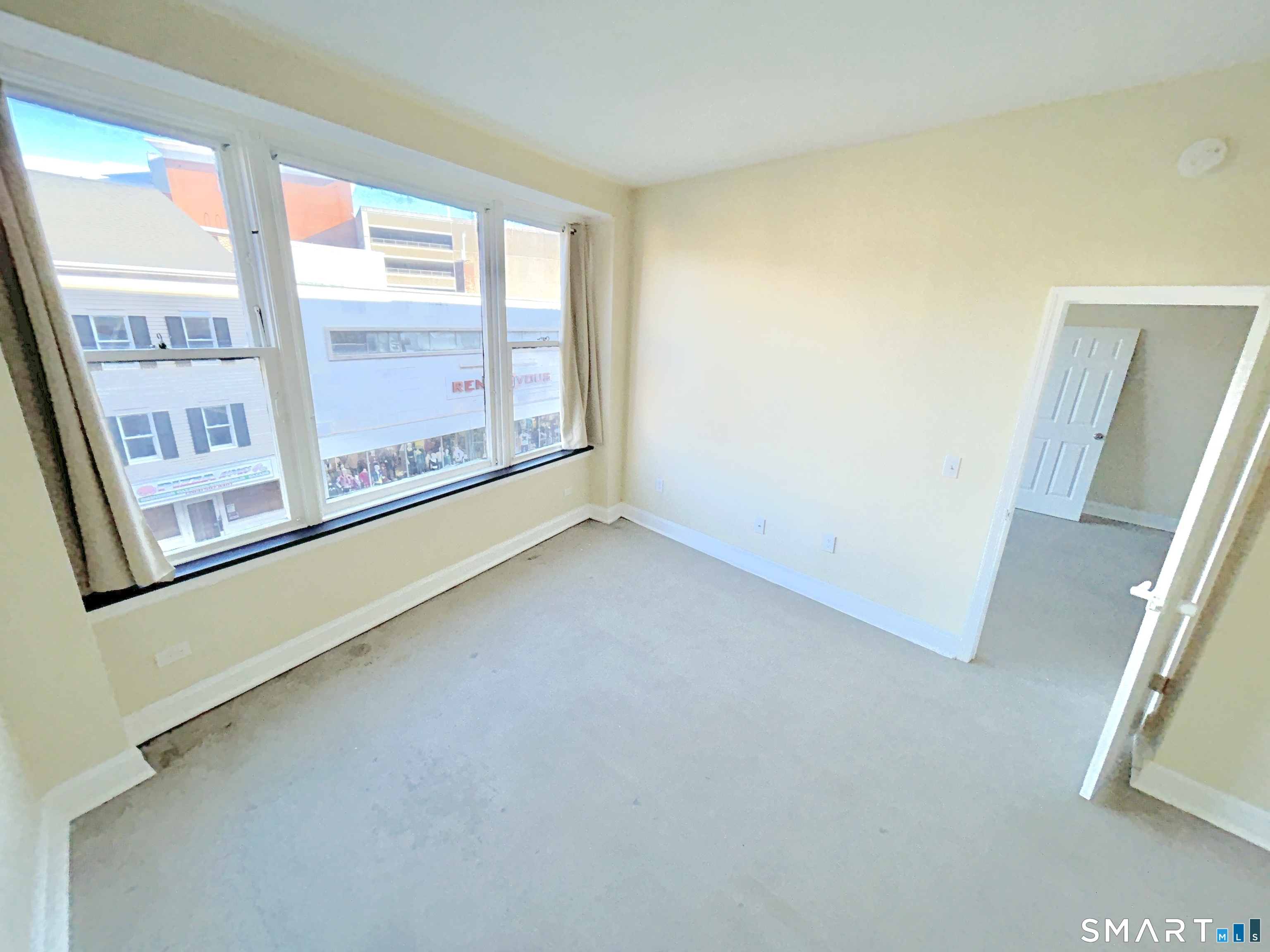 77 Bank Street, Unit 2B Waterbury, CT 06702 - Photo 7 of 11 an empty room with windows