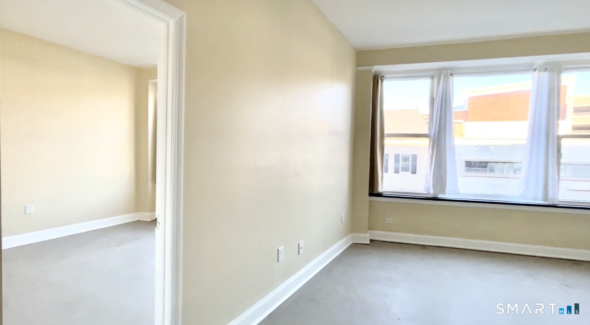 77 Bank Street, Unit 2B Waterbury, CT 06702 - Photo 10 of 11 an empty room with a window