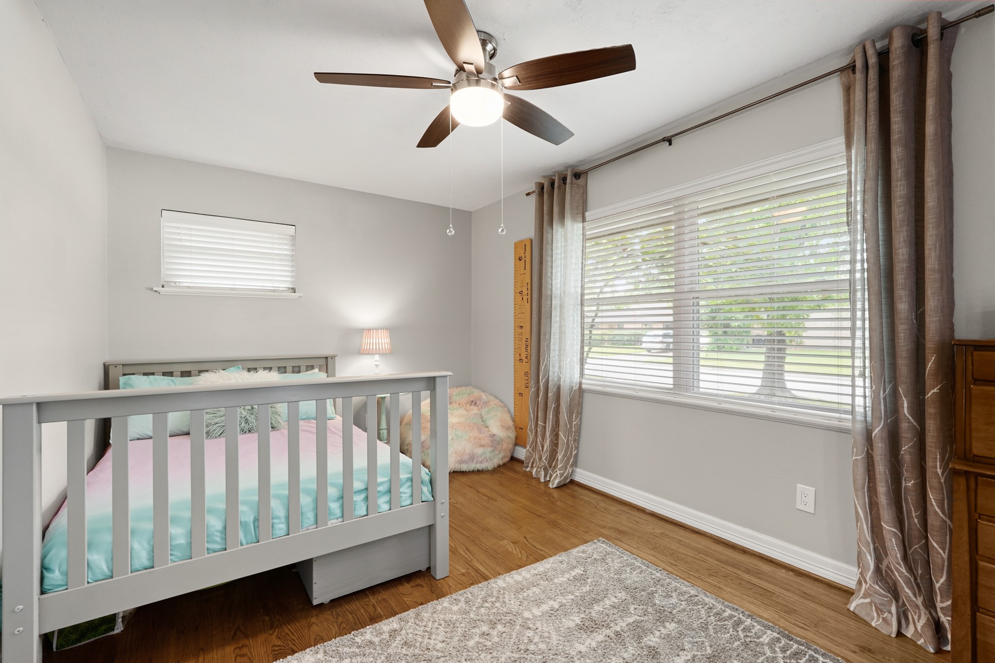 5242 Sanford Road Houston, TX 77035 - Photo 22 of 34 Secondary bedroom features hardwood floors, a large window to allow for plenty of light, ceiling fan, and huge walk in closet.