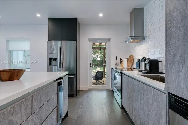 a kitchen with stainless steel appliances a sink and a refrigerator
