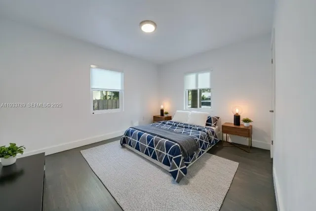 a bed sitting in a bedroom next to a window