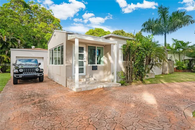 a view of a house with a couches and a yard