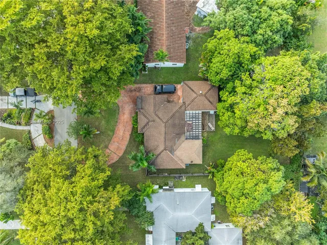 an aerial view of a house with a yard and garden