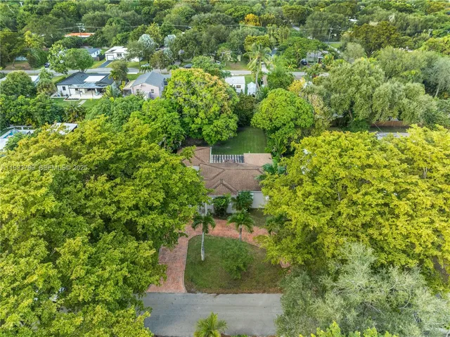 an aerial view of a house with a yard