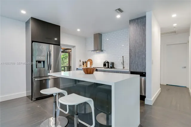 a kitchen with a table and chairs in it