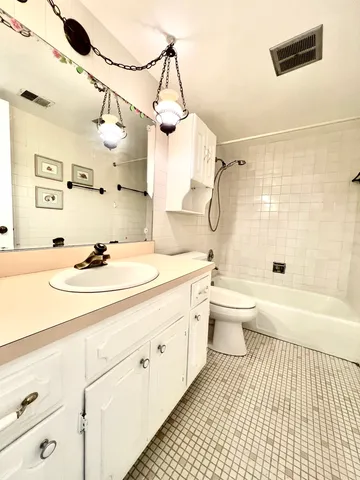 a bathroom with a sink a toilet and a bathtub