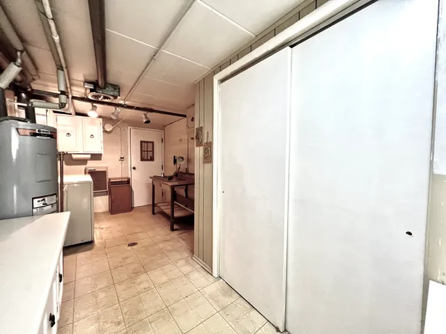 a view of a living room with furniture and a kitchen