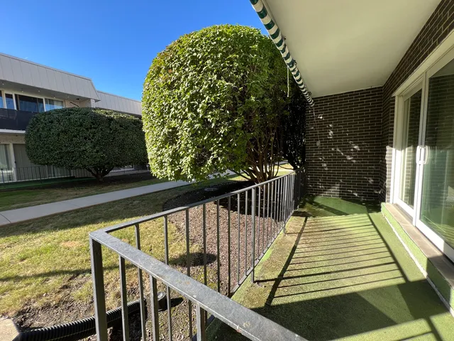 a view of balcony with wooden floor and fence