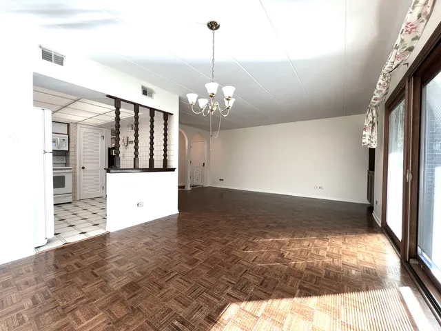 a view of a room with window and hardwood floor