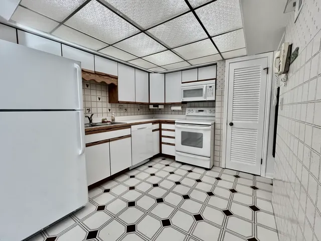 a kitchen with stainless steel appliances a refrigerator sink and cabinets