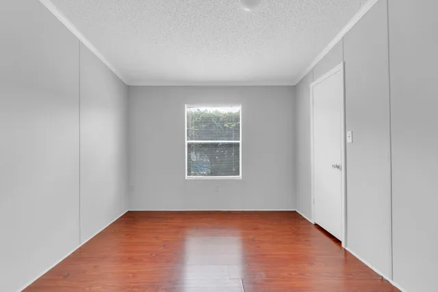 a bathroom with a granite countertop sink a toilet and a mirror