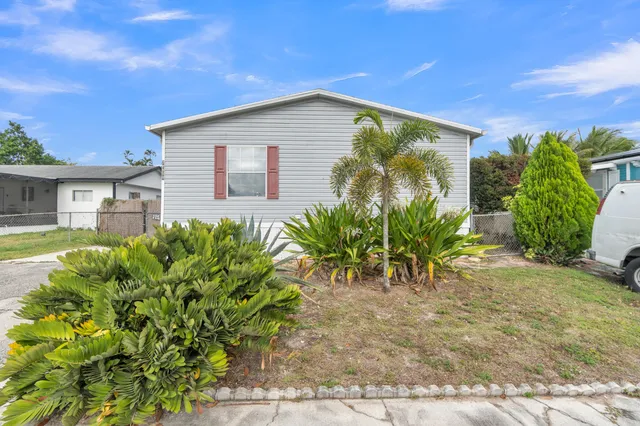 a kitchen with stainless steel appliances granite countertop a sink cabinets and wooden floor