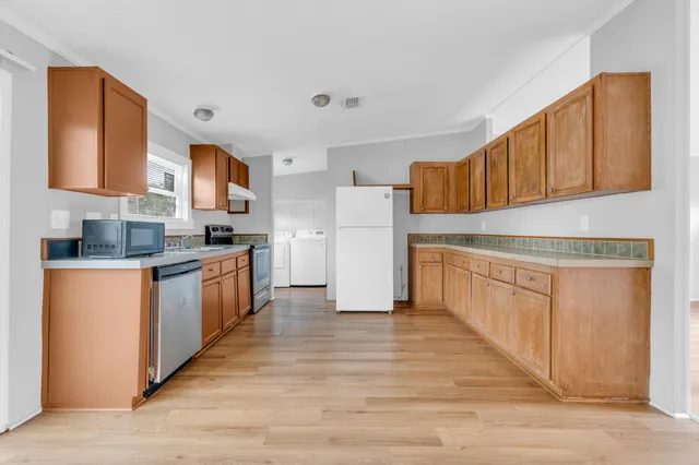 a view of a kitchen with a sink and a stove top oven