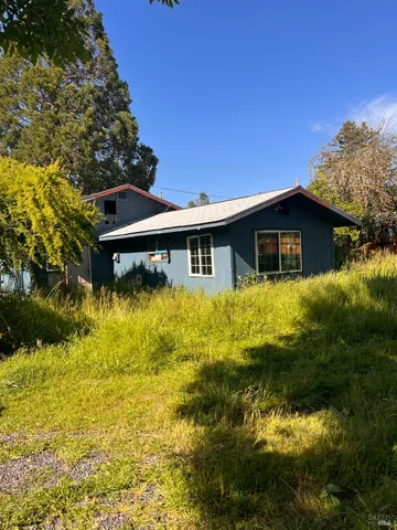 a front view of house with yard and swimming pool