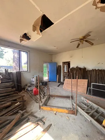 a view of a hall with wooden floor and windows