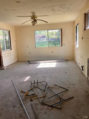a view of a livingroom with wooden floor and a window