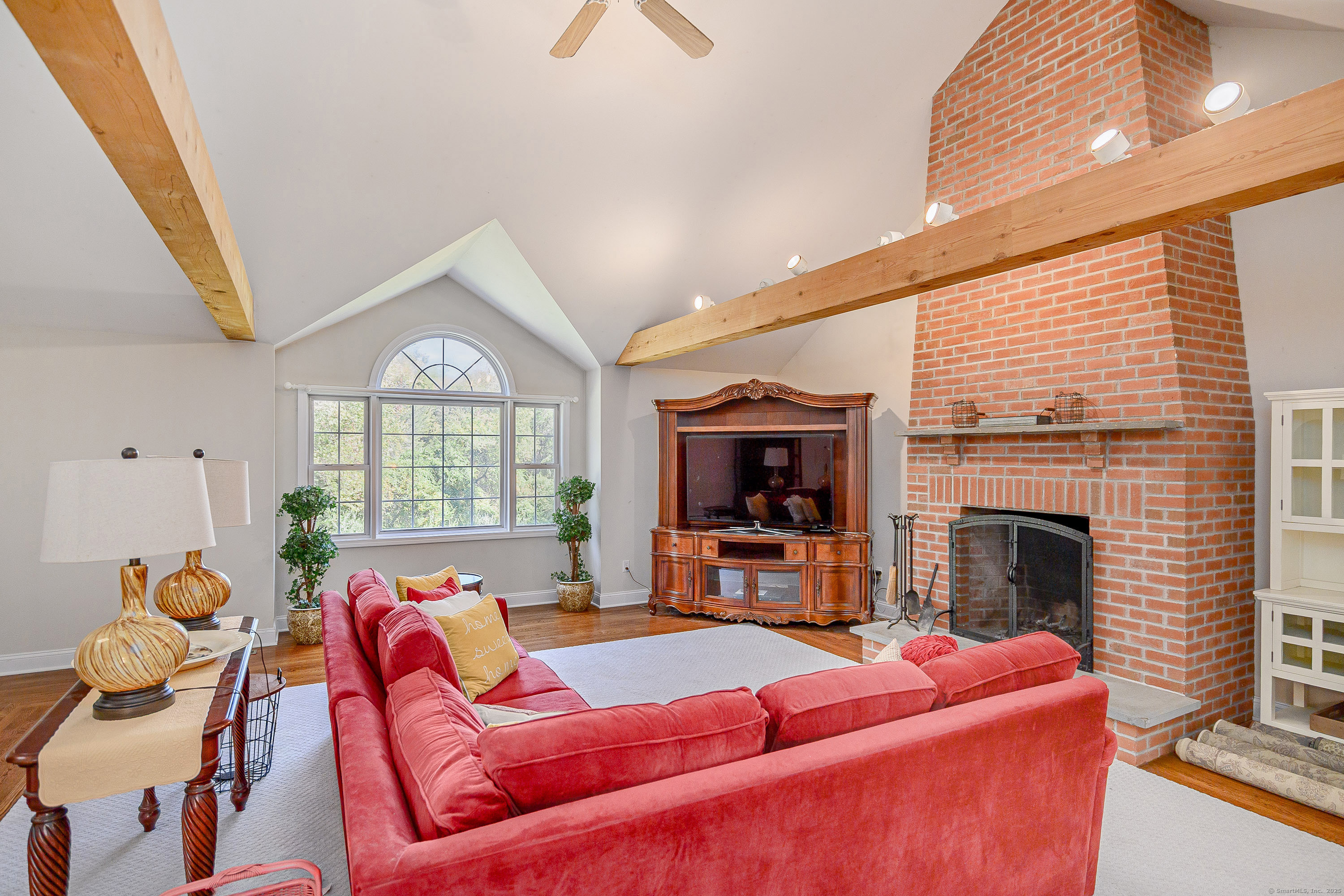 27 Pole Bridge Road Newtown, CT 06482 - Photo 16 of 39 a living room with furniture a fireplace and a flat screen tv
