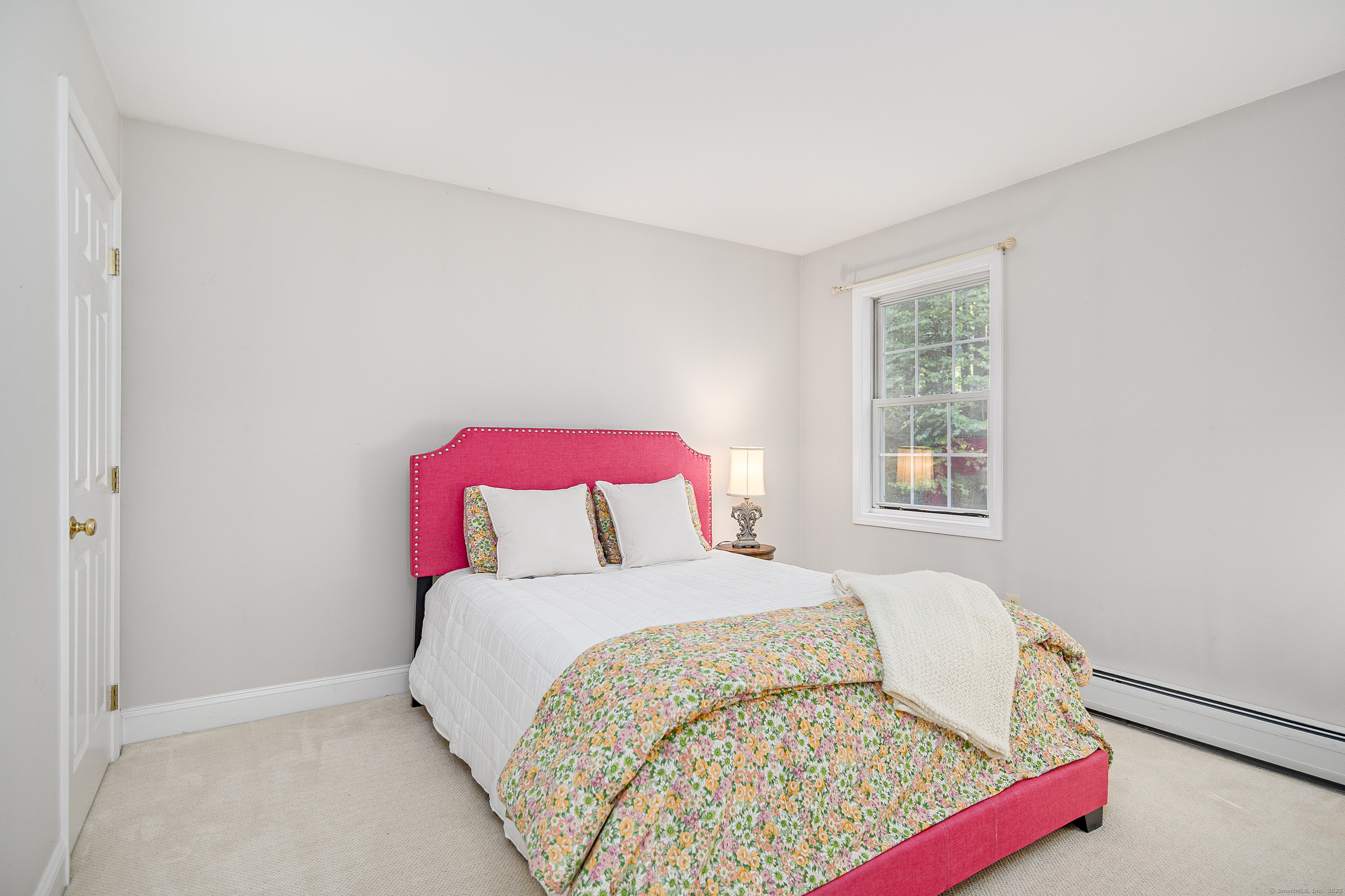 27 Pole Bridge Road Newtown, CT 06482 - Photo 23 of 39 a bed sitting in a bedroom next to a window