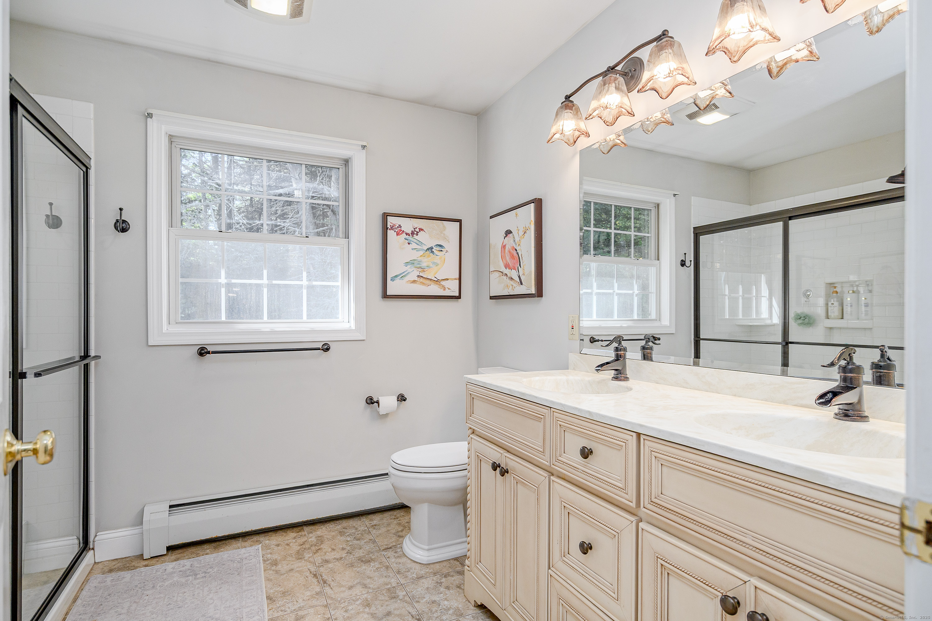27 Pole Bridge Road Newtown, CT 06482 - Photo 26 of 39 a bathroom with double vanity sink a large mirror a toilet a window and vanity