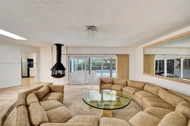 a living room with furniture and a lamp