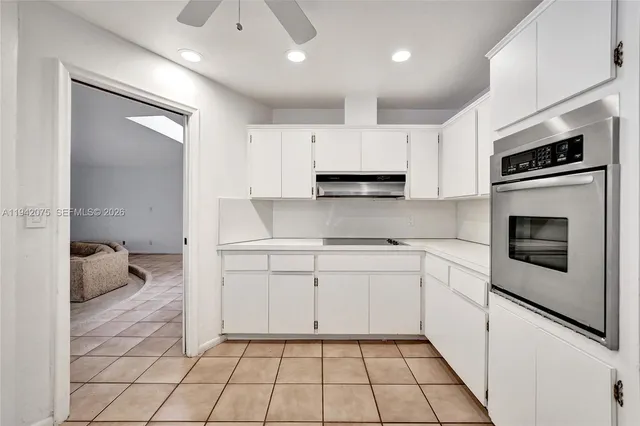 a bedroom with furniture and large windows