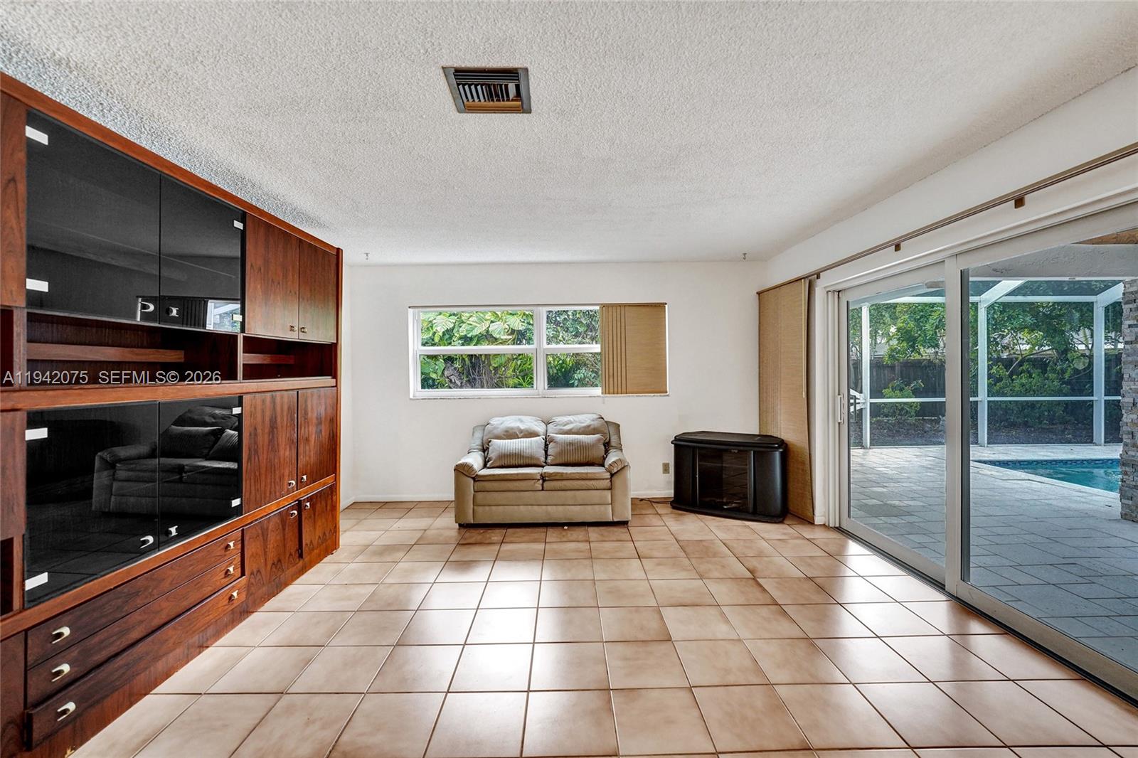 7420 Southwest 13th Street Plantation, FL 33317 - Photo 27 of 68 a living room with furniture and a flat screen tv