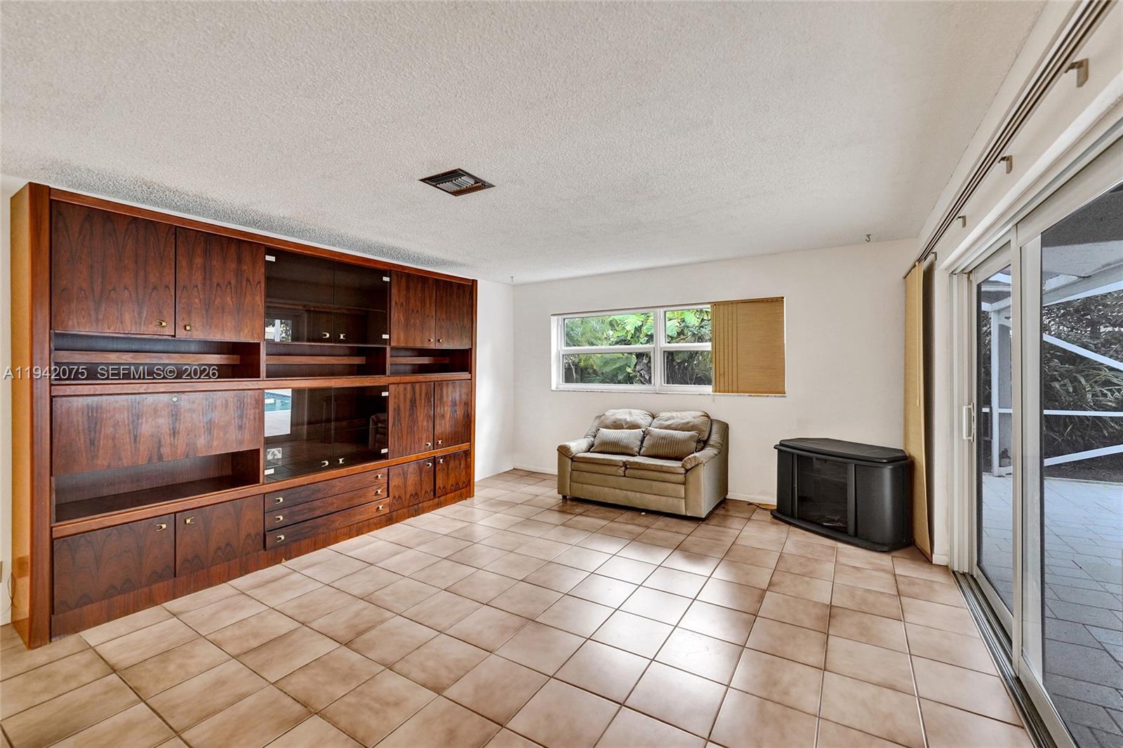 7420 Southwest 13th Street Plantation, FL 33317 - Photo 28 of 68 a kitchen with stainless steel appliances wooden cabinets and a stove top oven