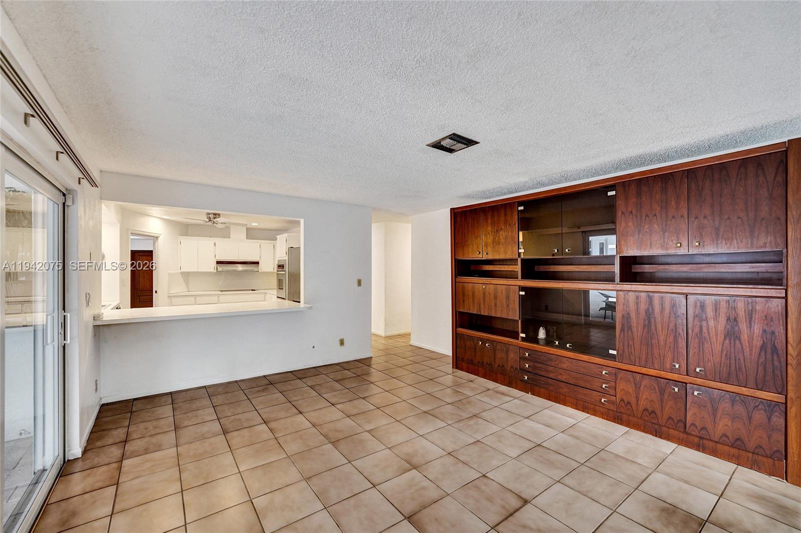 7420 Southwest 13th Street Plantation, FL 33317 - Photo 29 of 68 a kitchen with granite countertop a refrigerator and a stove top oven