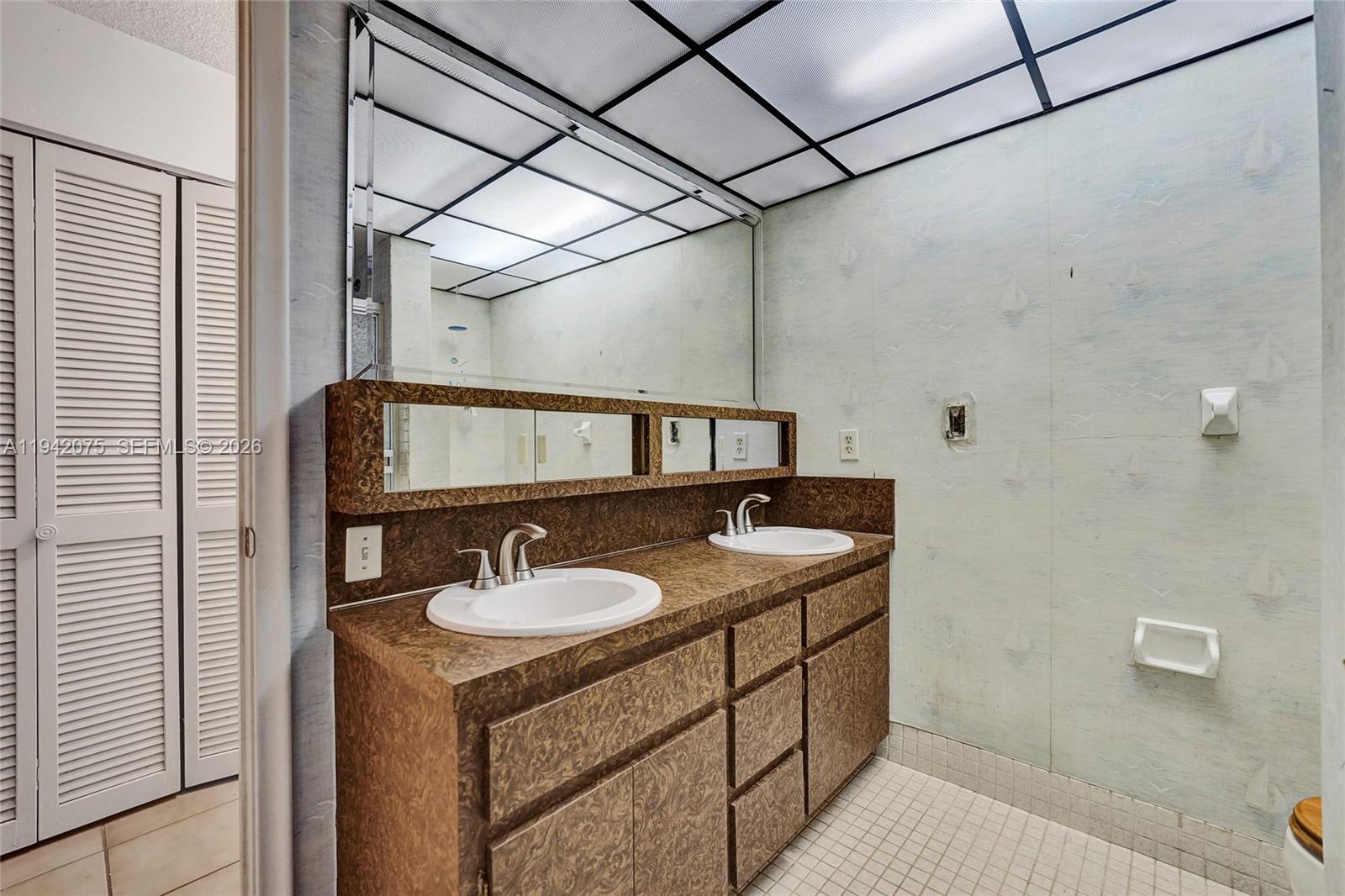 7420 Southwest 13th Street Plantation, FL 33317 - Photo 37 of 68 a bathroom with a sink and a mirror