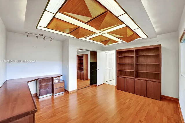 a spacious bathroom with a granite countertop sink a mirror and shower