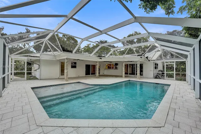 a view of a house with a backyard