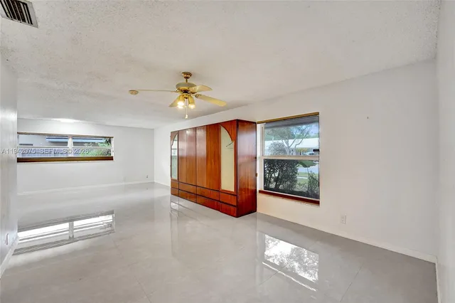 a view of a backyard with a patio and a yard