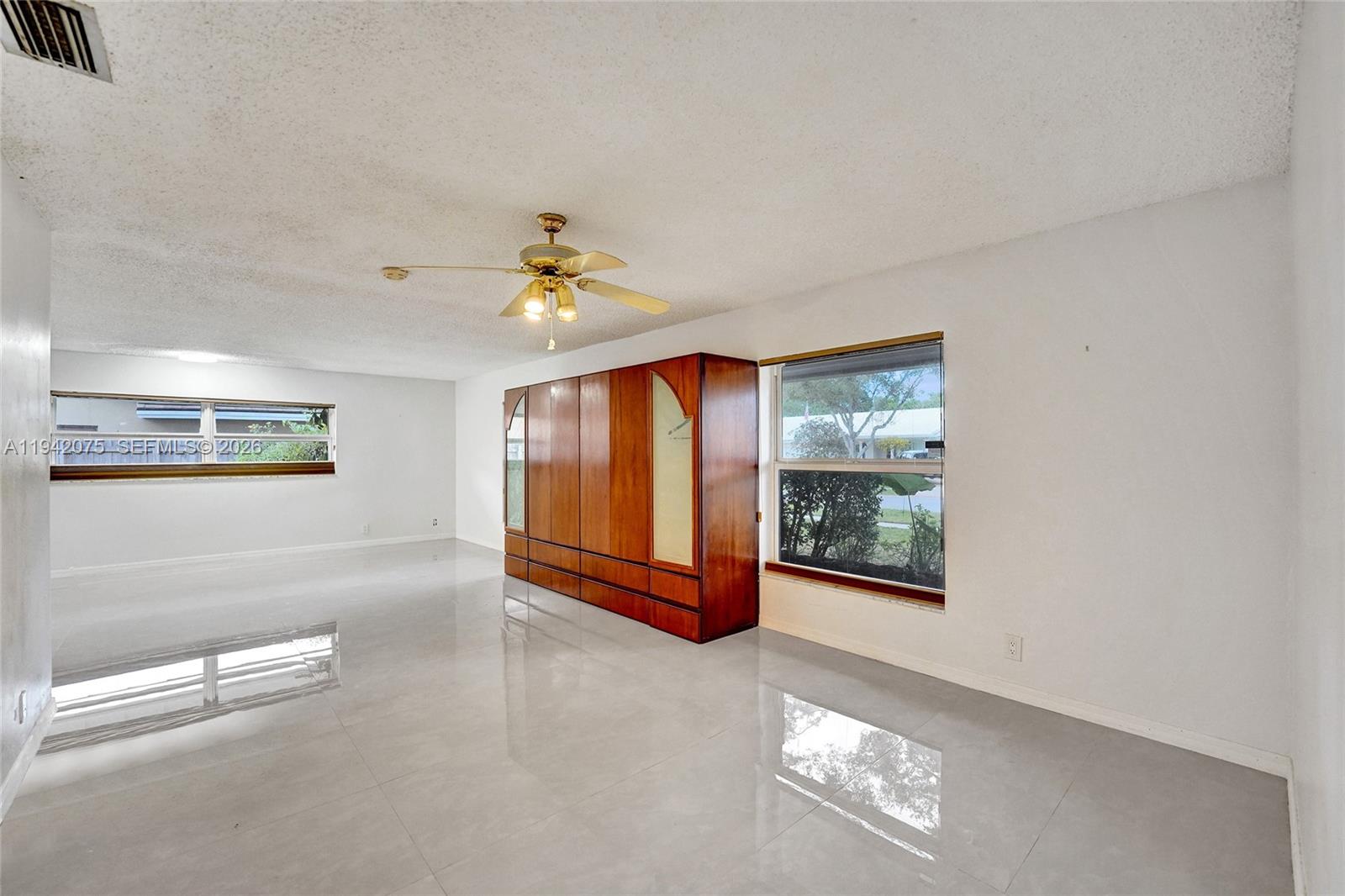 7420 Southwest 13th Street Plantation, FL 33317 - Photo 44 of 68 a view of an empty room with window and stairs