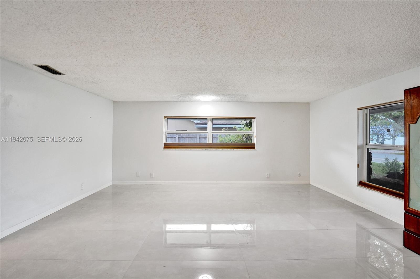 7420 Southwest 13th Street Plantation, FL 33317 - Photo 46 of 68 an empty room with windows and chandelier fan