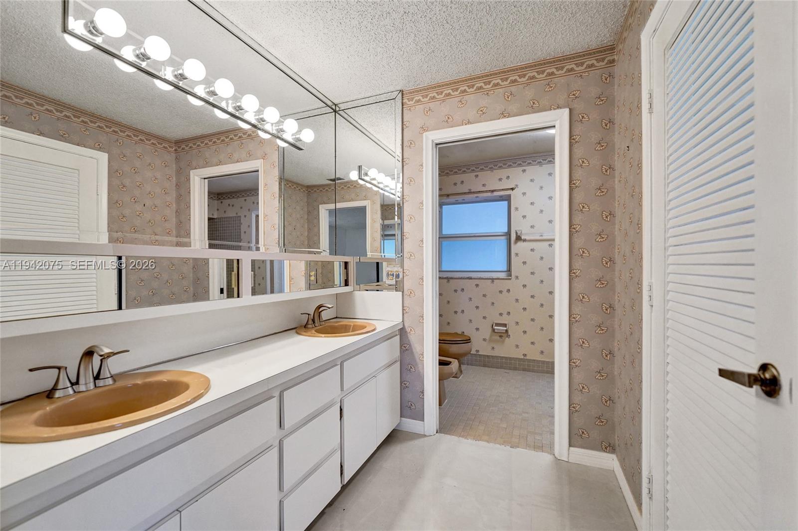 7420 Southwest 13th Street Plantation, FL 33317 - Photo 51 of 68 a spacious bathroom with a granite countertop sink a mirror and shower