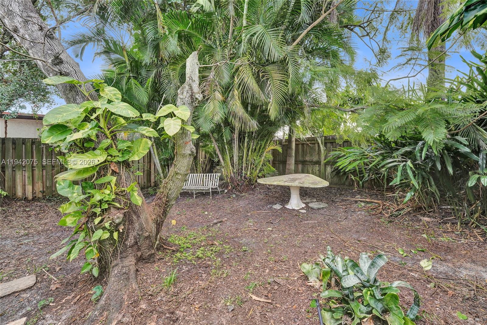 7420 Southwest 13th Street Plantation, FL 33317 - Photo 66 of 68 a wooden fence with some plants in the back