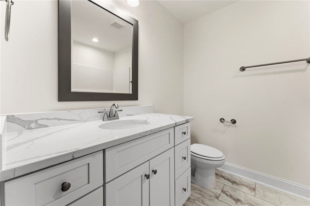 505 Fire Tower Road Williamston, SC 29697 - Photo 26 of 37 This bright bathroom features a vanity with ample storage and a sleek toilet.