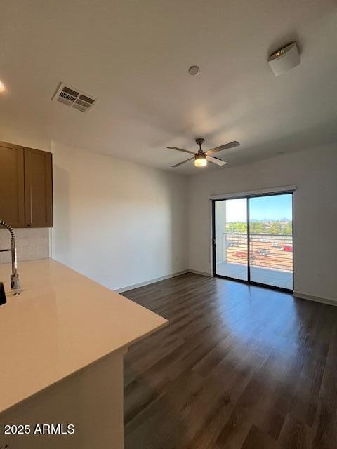 1225 North Arizona Avenue, Unit A1 1 Gilbert, AZ 85233 - Photo 2 of 20 a view of an empty room with wooden floor and a window