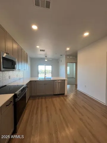 a view of a kitchen with a sink and microwave