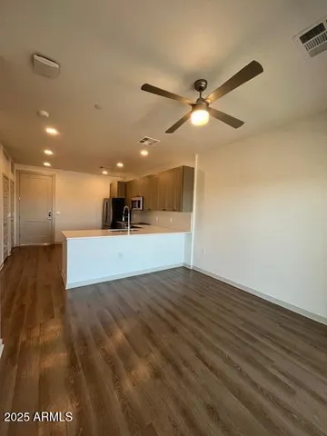 a view of a kitchen with a sink and a refrigerator