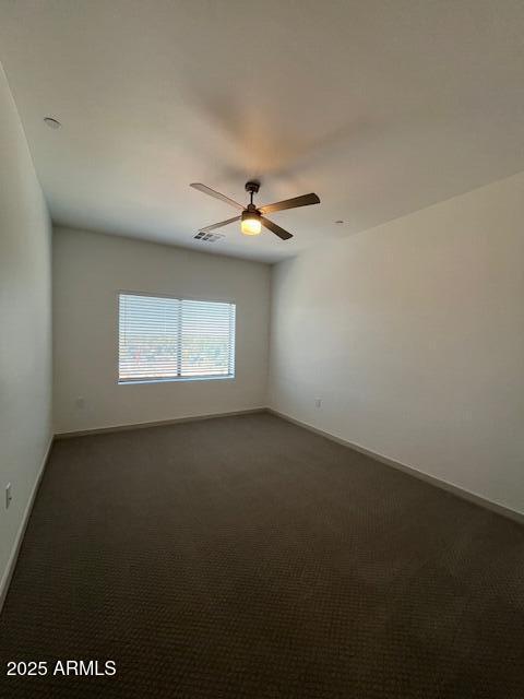 1225 North Arizona Avenue, Unit A1 1 Gilbert, AZ 85233 - Photo 5 of 20 an empty room with a ceiling fan and window