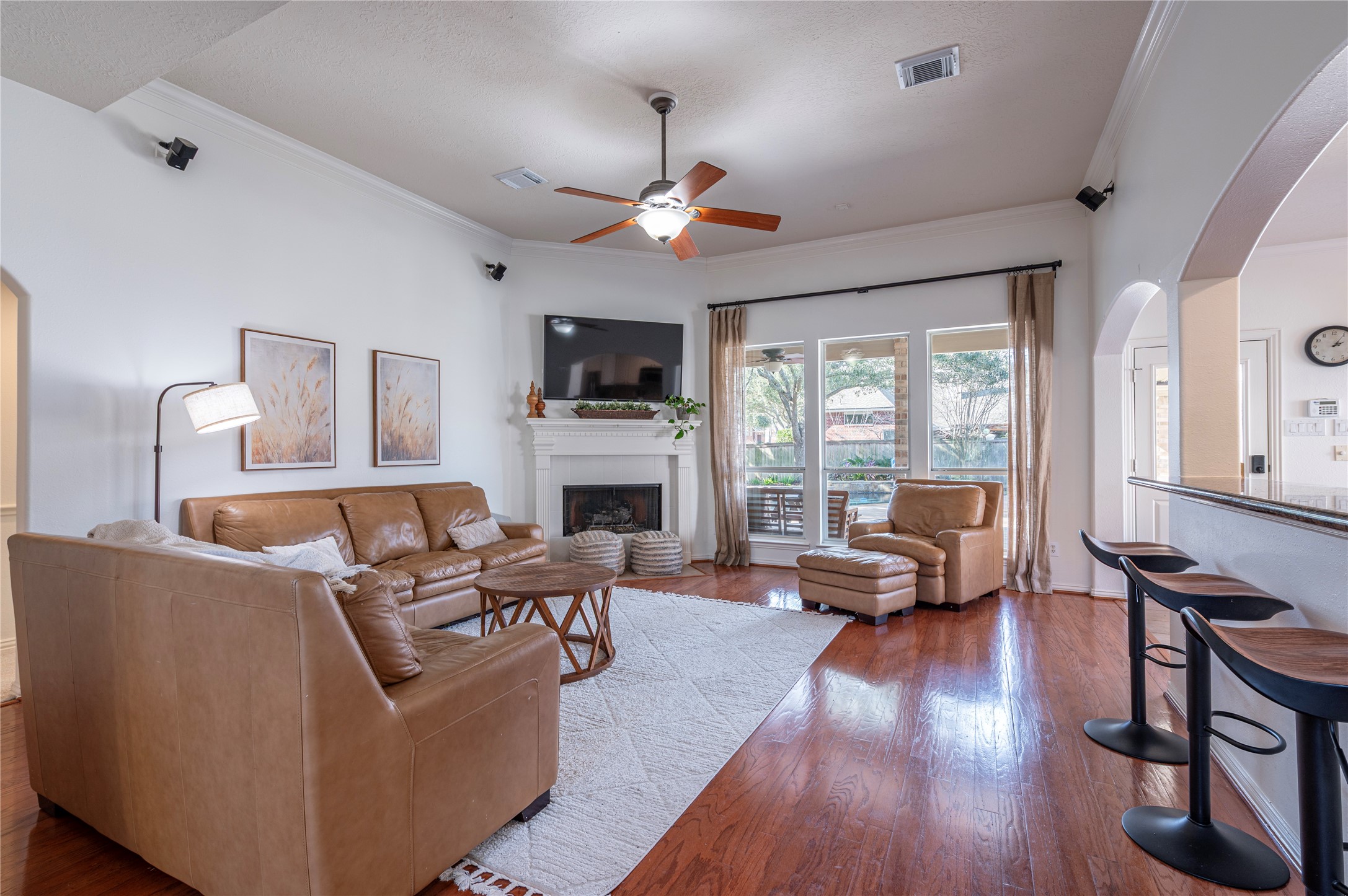 700 Red Oak Lane Friendswood, TX 77546 - Photo 12 of 48 a living room with furniture fireplace and a flat screen tv