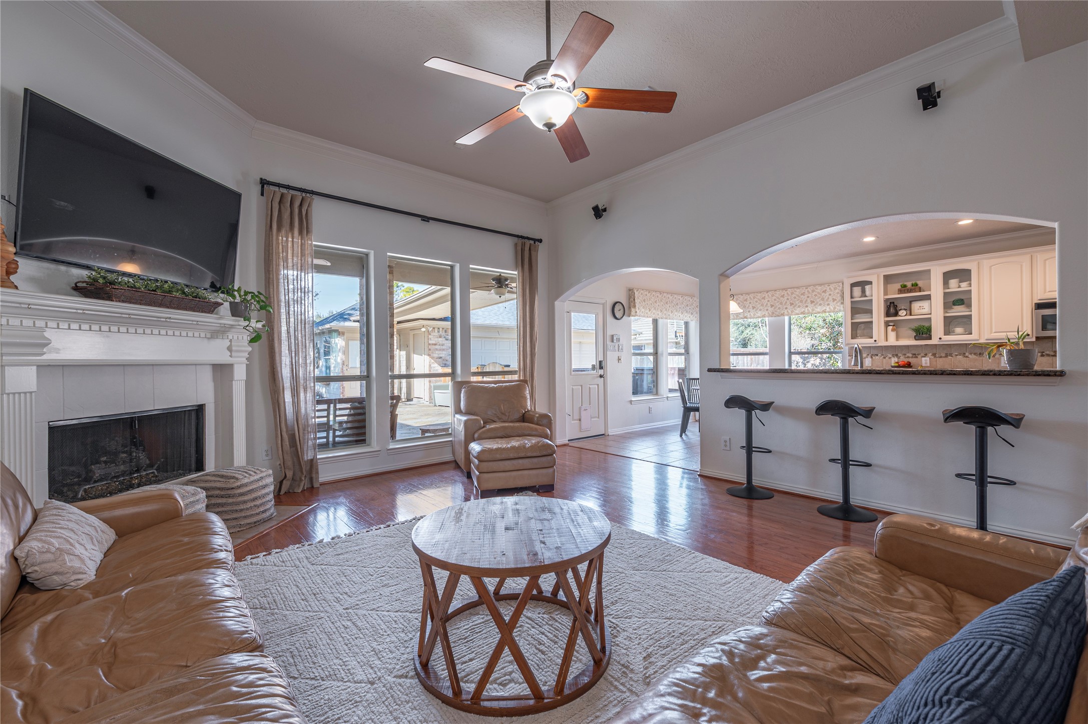 700 Red Oak Lane Friendswood, TX 77546 - Photo 13 of 48 a living room with furniture a fireplace and a flat screen tv