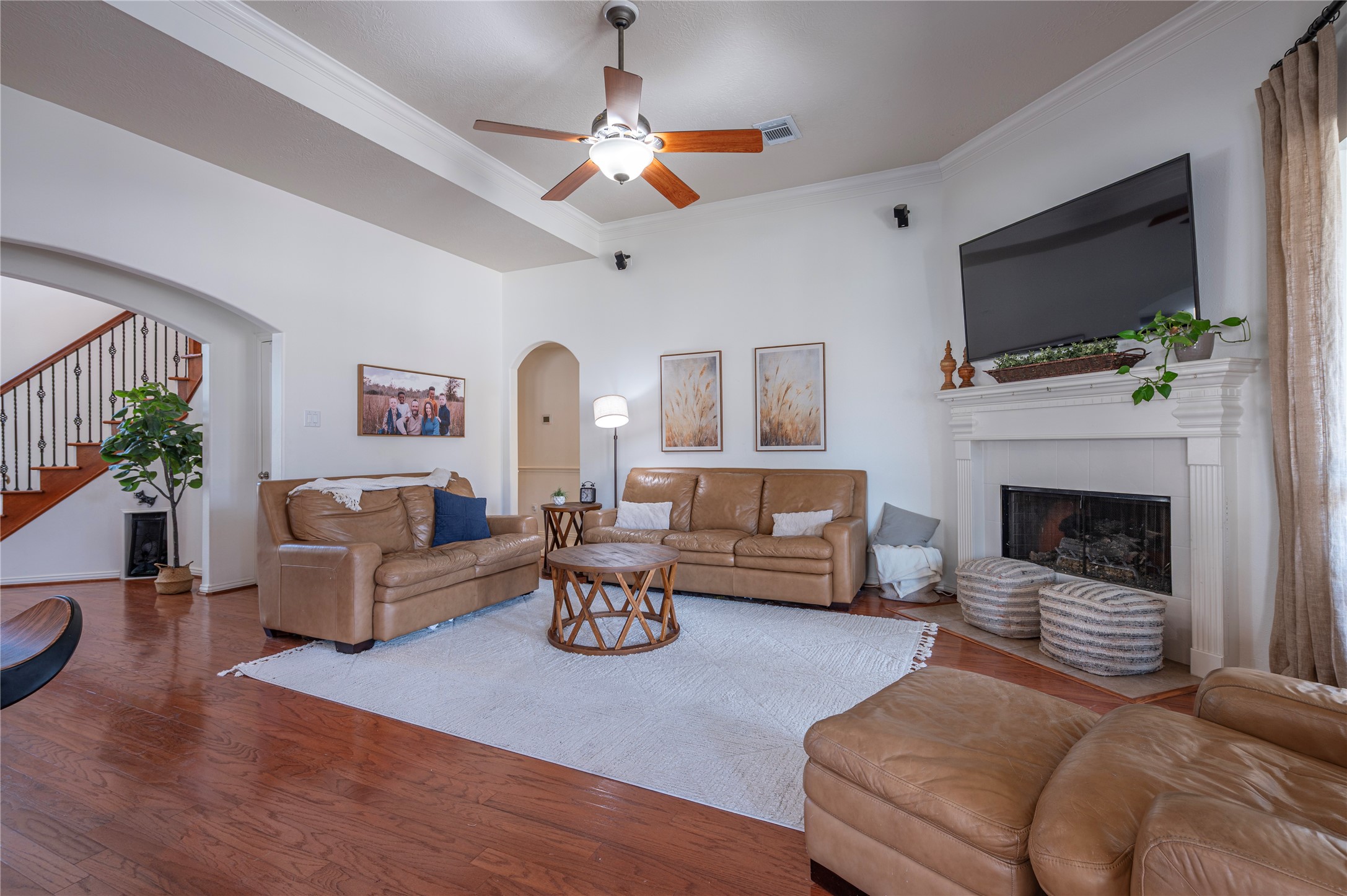 700 Red Oak Lane Friendswood, TX 77546 - Photo 14 of 48 a living room with furniture a flat screen tv and a fireplace